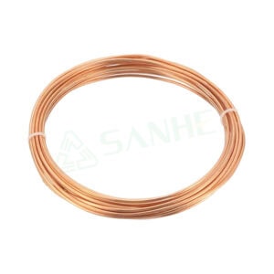 Close-up of a copper capillary tube coil used in HVAC systems for precise refrigerant flow control.